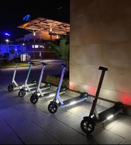 three scooters parked next to a building at night at Apartment on the Plaza in Villamartin