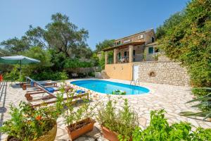 an external view of a house with a swimming pool at Villa Elia, ,Platanos, Paxos in Koútsion