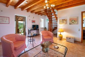 a living room with two chairs and a table at Villa Elia, ,Platanos, Paxos in Koútsion