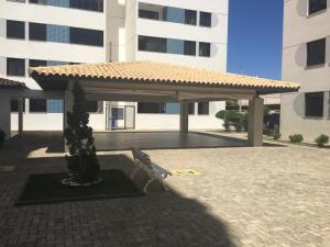 a pavilion with a bench in front of a building at LAZER NA ATALAIA in Aracaju