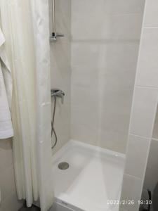 a white shower with a shower curtain in a bathroom at Hotel Paulina in Făleşti +32 photos