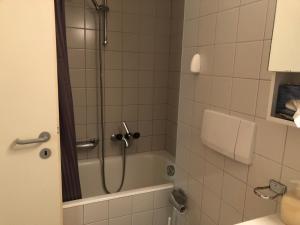 a bathroom with a shower with a tub at Résidences du Chamossaire in Leysin