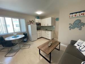 a living room with a couch and a table at Studio BTS - Lauderdale-By-The-Sea in Pompano Beach
