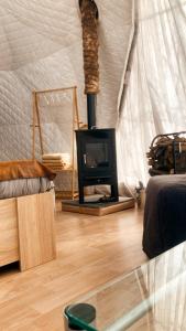 a living room with a fireplace in a tent at Camping Alpujarras in Laroles