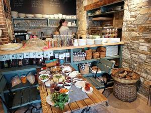 a table with plates of food on it in a kitchen at Pulinda Pansiyon in Doğanbey