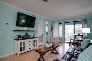 a living room with a couch and a tv on the wall at The Rustic Anchor in Hilton Head Island