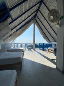 a room with beds and a view of the ocean at Hostel Beach House in Rincón