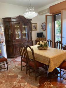 a dining room with a table with chairs and a refrigerator at Casa Vacanza a Limbiate in Limbiate