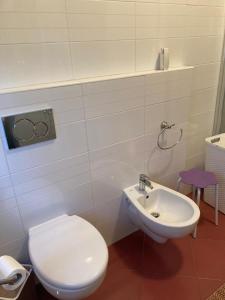 a bathroom with a white toilet and a sink at Casa Vacanza a Limbiate in Limbiate