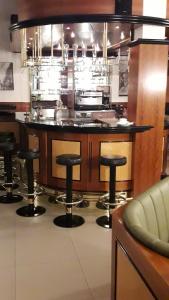a kitchen with a island with bar stools at Pension Horvath jun. in Guntramsdorf