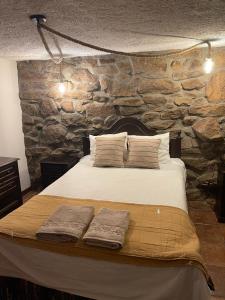 En eller flere senge i et værelse på Casa da Aldeia