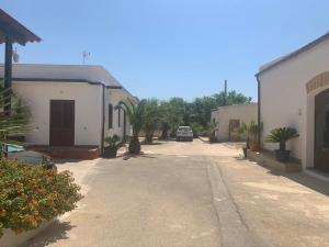 an empty street with a car parked in the distance at Casa Vacanze Mandriavecchia in Petrosino