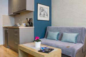 a living room with a couch and a table at Holiday Meteora B in Kalabaka