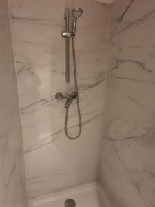 a shower with a shower head in a bathroom at B96 suites in Brussels