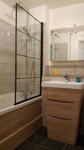 a bathroom with a shower and a sink and a tub at Lichfield 2-bed whole apartment in Lichfield