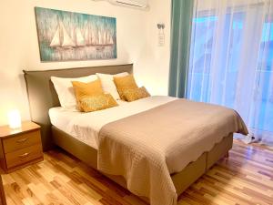 a bedroom with a large bed with two pillows at Apartment Lucie3 in Biograd na Moru