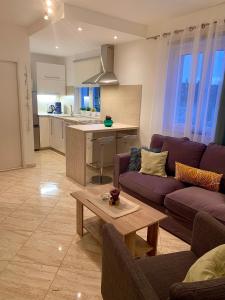 a living room with a purple couch and a table at Apartment Lucie3 in Biograd na Moru