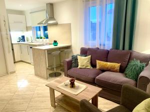 a living room with a purple couch and a table at Apartment Lucie3 in Biograd na Moru +14 photos