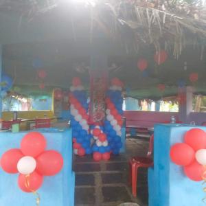 a room with a bunch of red and blue balloons at GOLDENGARDEN COTTAGES in Hampi