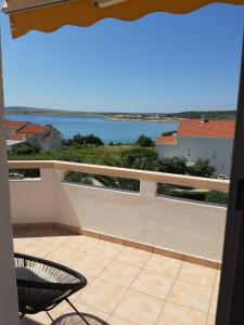 a balcony with a view of the ocean at Apartments Donadic I, Caska in Novalja
