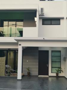 a facade of a building with a black door at 48 悠之处NO . 48, PERSIARAN ALAM IMPIAN 3 VILLA RIADAH ALAM IMPIAN PANGKOR, 32300 PANGKOR , PERAK. in Pangkor