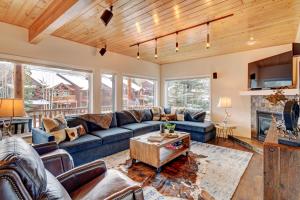 a living room with a couch and a table at Luxury Slopeside Condo #97A Next to Ski Resort With Hot Tub & Great Views - 500 Dollars Of FREE Activities & Equipment Rentals Daily in Winter Park