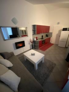a living room with a couch and a table at Apartments-LUCKY STAR,NOVALJA -PAG in Novalja