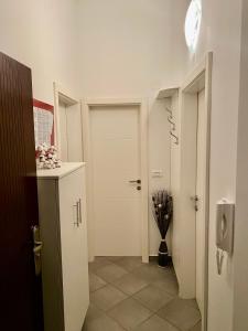 a hallway with a white door and a vase of flowers at Apartments-LUCKY STAR,NOVALJA -PAG in Novalja +40 photos