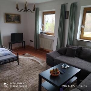 a living room with a couch and a table at Ferienwohnung Aicher in Kirchanschöring