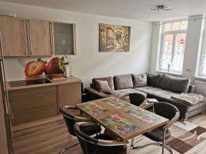 a living room with a couch and a table at Ferienwohnung Northeim City in Northeim