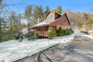 a log home in the snow with christmas trees at Boone Bounty in Boone