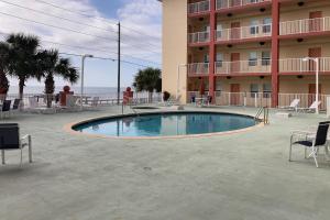a swimming pool in front of a hotel at Paradise Shores 210 in Mexico Beach