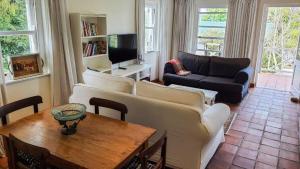 a living room with a couch and a table at Belvidere102 in Knysna