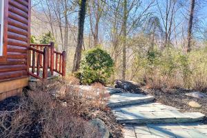 a stone walkway next to a house with a fence at Black Bear Hideaway Cabin in Gatlinburg