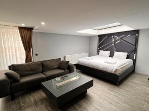 a hotel room with a bed and a couch at Kent Suit Otel in Istanbul