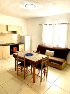 a living room with a table and a couch at Paceville Apartments in St Julian's