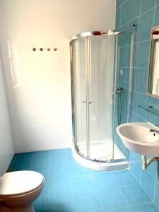 a bathroom with a shower and a toilet and a sink at Paceville Apartments in St Julian's
