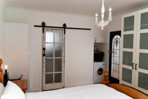 a bedroom with a bed and a door at Beach Front Beauty in Melbourne