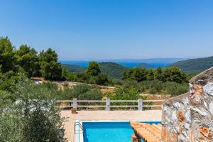 a swimming pool with a view of the mountains at Villa Jasmine in Skopelos Town