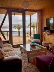 a living room with a view of the ocean at La Ritoqueña Hotel de Playa in Concón