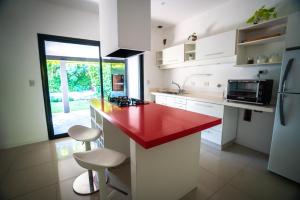 a kitchen with a red counter top in a room at Casa con Piscina en Adrogué in Adrogué