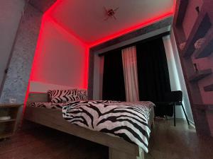 a bedroom with a bed with a red light at Sekulic Apartments in Loznica