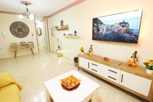 a living room with a flat screen tv on the wall at Ronda Centro - Relax in Ronda