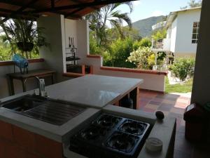 a kitchen with a sink and a stove top oven at Finca Mirador la Giralda in Roldanillo
