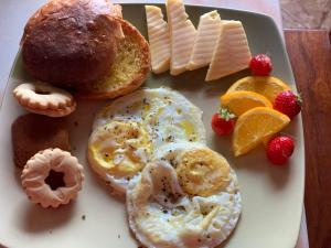a plate of breakfast food with pastries and cheese at Villa Vicente in Vila Nova Sintra