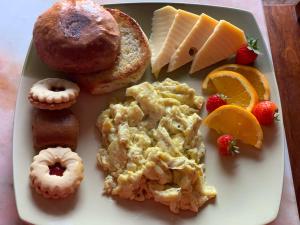a plate of breakfast foods on a table at Villa Vicente in Vila Nova Sintra