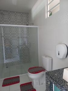a bathroom with a toilet and a glass shower at Casa milagres in São Miguel dos Milagres +20 photos