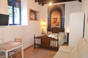 een slaapkamer met een bed en een woonkamer bij ALCAZAR VIEJO PARKING Tourist Córdoba in Córdoba