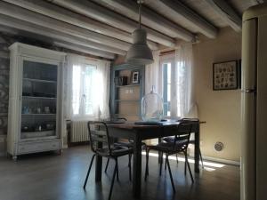 a dining room with a table and chairs at Saxa Apartment in Verona