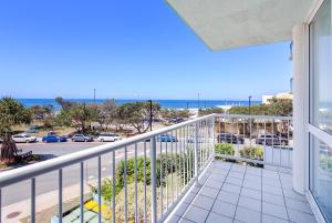 a balcony with a view of a parking lot at Capeview Apartments - Right on Kings Beach in Caloundra
